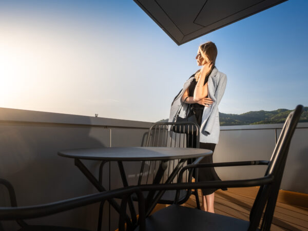 Woman enjoying the view from a hotel balcony.