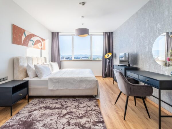 Hotel room with double bed and sitting area.