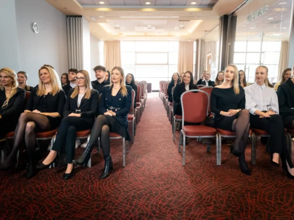 Audience seated in the Century conference room.