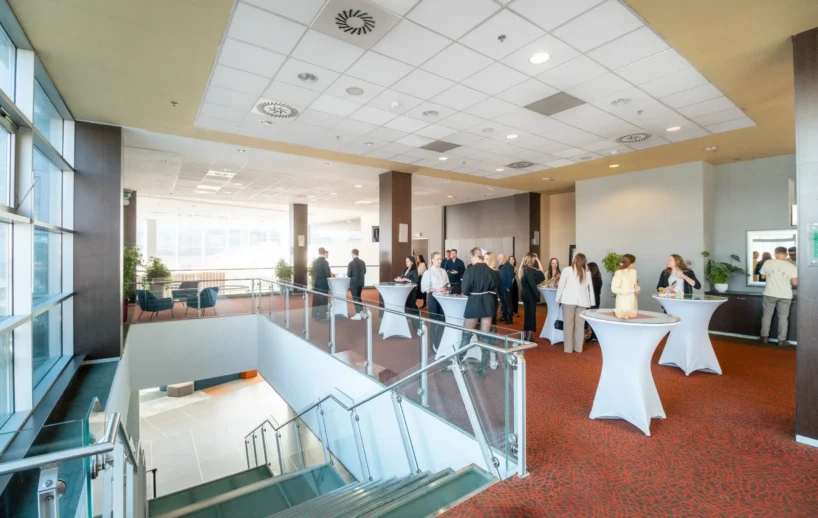 Guests networking in the conference foyer.