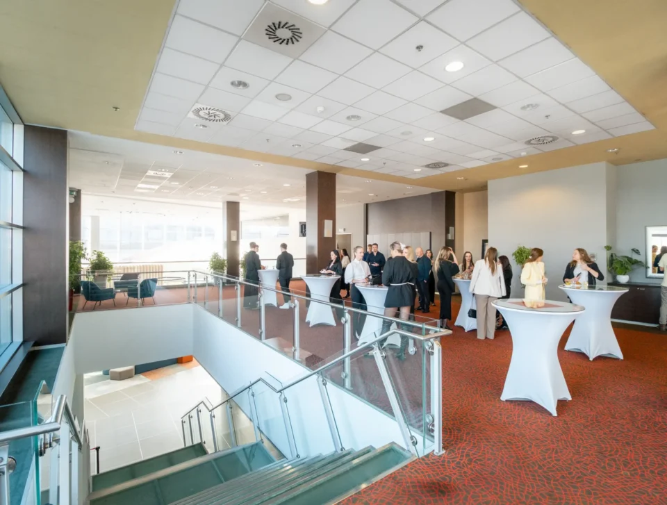 Guests networking in the conference foyer.