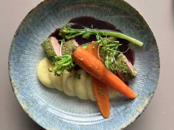 Plated vegetable and meat dish.