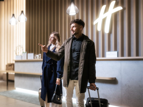 Guests arriving at Holiday Inn Žilina reception.