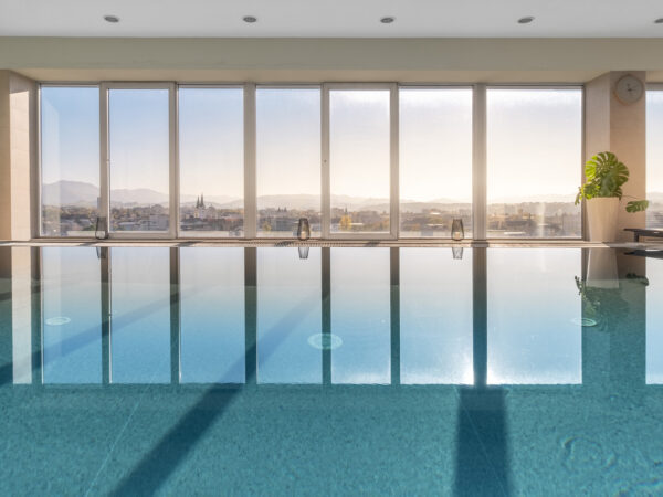 Indoor pool with panoramic city views.
