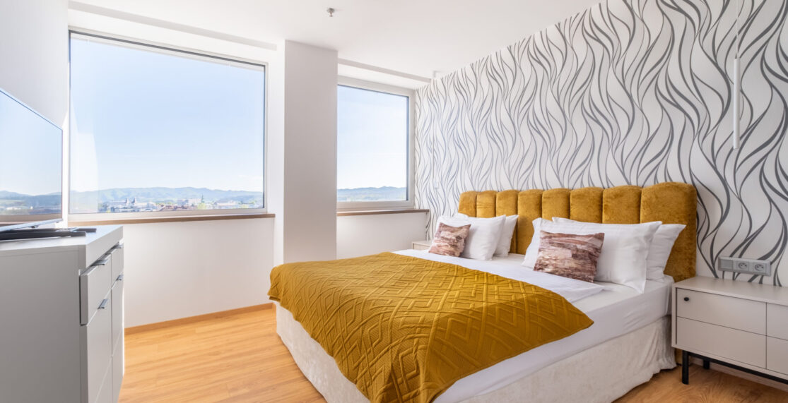 Apartment bedroom with mountain view.